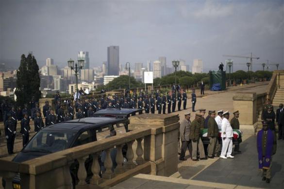 Military personnel carry the remains of the late Nelson Mandela at the Union Buildings in Pretoria